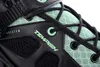 A close-up view of the side of a black and green inline skate, showing the lacing system and branding. Podgląd zdjęcia produktu