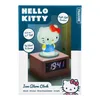 The image shows the packaging of a Hello Kitty alarm clock. The packaging features a prominent image of the Hello Kitty alarm clock, along with text describing its features and brand. Podgląd zdjęcia produktu