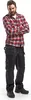 A man wearing work pants and a plaid shirt, standing with his arms crossed. Produktbild-Vorschau