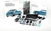 A collection of items for a Porsche 911 Advent Calendar, including model car parts, books, and accessories, laid out on a white surface. Náhľad obrázku produktu