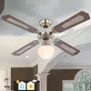 A ceiling fan with wooden blades and a glass light fixture is shown installed on a white ceiling. Náhľad obrázku produktu