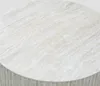 A close-up view of a round table with a beige and white marbled surface. Náhled obrázku produktu