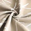 A close-up view of a crumpled piece of fabric with a sand-colored background and a white abstract pattern. Produktbild-Vorschau