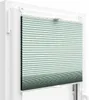 A close-up view of a pleated blind installed in a window frame. Produktbild-Vorschau