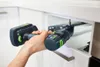 A person is using a cordless drill to install a drawer slide in a kitchen cabinet. Voir les images du produit