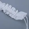 A close-up of white ruffled fabric trim with two white strings hanging from the end. Produktbild-Vorschau