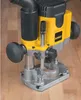 A close-up shot of a DeWALT router on a wooden surface. Produktbild-Vorschau