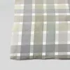 A close-up of green and gray plaid seersucker bedding. Produktbild-Vorschau