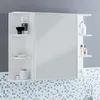A white bathroom cabinet with a mirror and shelves, displaying various toiletries. Produktbild-Vorschau