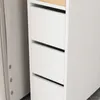 A close-up view of a white roll cabinet with three drawers and a wooden top. Produktbild-Vorschau