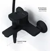 A black bathroom faucet mounted on a white wall, with measurement indicators. Produktbild-Vorschau