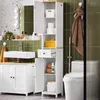 A white bathroom storage cabinet and vanity are shown with a sink and faucet. The cabinet is tall and narrow, with shelves, a drawer, and doors. A toilet is partially visible on the right. Produktbild-Vorschau