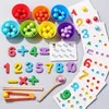 A collection of Montessori math learning tools, including colorful counting beads, number tiles, and math symbol tiles, arranged on a light gray surface. Produktbild-Vorschau