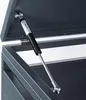 Close-up view of a gas strut attached to the lid of a dark gray trash can enclosure. Produktbild-Vorschau