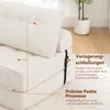 Close-up of a white sofa bed with straps and text overlays highlighting features. Podgląd zdjęcia produktu