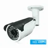 A white bullet IP camera with a black sunshade is mounted on a white bracket against a white background. Náhľad obrázku produktu