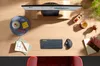 A top-down view of a desk with a computer monitor, keyboard, mouse, and various office supplies. Anteprima dell’immagine prodotto