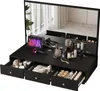 A black vanity desk with a large mirror, featuring various makeup and hair products, a tablet, and a hairdryer. Voir les images du produit