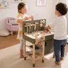 Two children playing with a wooden toy workbench in a bright, domestic setting. Náhled obrázku produktu
