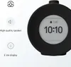 A close-up marketing image of a round, black digital alarm clock with an E-ink display showing the time and an alarm icon. Text and icons describing features are on the left side of the image. Anteprima dell’immagine prodotto