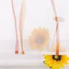 A close-up of sunflowers with sheer orange and white fabric draped over them. Produktbild-Vorschau