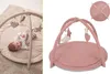 A baby playing on a play gym and a separate product shot of the play gym. Produktbild-Vorschau