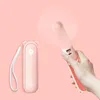 A hand holding a pink portable fan with a blurred background. Anteprima dell’immagine prodotto