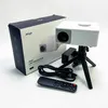 A mini projector, its box, remote control, and tripod are arranged on a white surface. Produktbild-Vorschau
