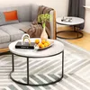 A living room scene with two coffee tables, a sofa, and a rug. Voir les images du produit