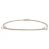A beige ring with white rollers on a white background. Produktbild-Vorschau