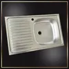 A stainless steel kitchen sink with a drainboard is shown from a slightly elevated angle against a black background. Podgląd zdjęcia produktu