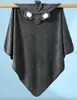 A gray hooded towel with an elephant face design is hanging from a wooden rod against a light blue background. Produktbild-Vorschau