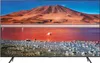 A television displaying a vibrant landscape image of a pink lake with a mountain in the background. Produktbild-Vorschau
