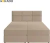 A studio shot of a beige boxspring bed with a tufted headboard, presented against a white background. Produktbild-Vorschau