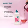 A bottle of dishwashing rinse aid is shown next to a glass being filled with a pink liquid. Produktbild-Vorschau