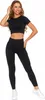A woman is posing in a black workout set. Produktbild-Vorschau