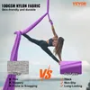 A woman performing aerial yoga with a purple hammock, comparing it to another fabric. Podgląd zdjęcia produktu