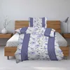A neatly made bed with floral patterned bedding. Produktbild-Vorschau