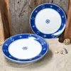 Two plates with a nautical theme are arranged on a sandy surface with wooden planks in the background. Podgląd zdjęcia produktu