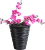 A potted artificial orchid plant with pink flowers in a black textured pot. Voir les images du produit