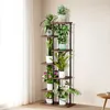 A multi-tiered plant stand filled with various potted plants, placed indoors near a window with sheer curtains. Produktbild-Vorschau
