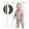 A baby is standing in front of a white baby gate. A close-up inset shows a detail of the gate's locking mechanism. Náhľad obrázku produktu