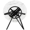 The underside of a round marble-patterned table with black metal legs. Produktbild-Vorschau