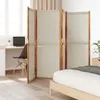 A room divider is placed in a bedroom next to a bed and a desk area. Voir les images du produit