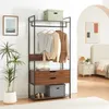A bedroom scene with a wardrobe rack, nightstand, and bed. Náhled obrázku produktu