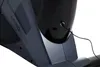 A close-up view of the base of a black and gray exercise machine, showing a power cord plugged into a port. Produktbild-Vorschau