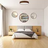 A bedroom scene with a bed, nightstands, and decorative mirrors on the wall. Anteprima dell’immagine prodotto