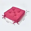 A square seat cushion with tufted detailing and ties, shown on a white background with dimensions indicated. Náhled obrázku produktu