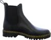 A black Chelsea boot with yellow stitching on a white background. Produktbild-Vorschau