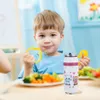 A young boy is sitting at a table with a plate of food and a thermos bottle. Produktbild-Vorschau